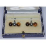 A pair of Mappin & Webb silver cufflinks, each set with a pair of quartz tiger's eye beads, London