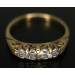 A five stone diamond ring, the old European cut diamonds in scroll work setting and weighing approx.