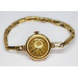 A ladie's hallmarked 18ct gold wristwatch with strap marked '18ct', gross wt. 13.29g.