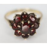 A hallmarked 9ct gold garnet cluster ring, the cluster head approx. 11mm x 11mm, gross wt. 2.74g,