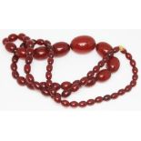 A single strand of graduated cherry bakelite beads, length 70cm, beads ranging from 8mm - 29mm,