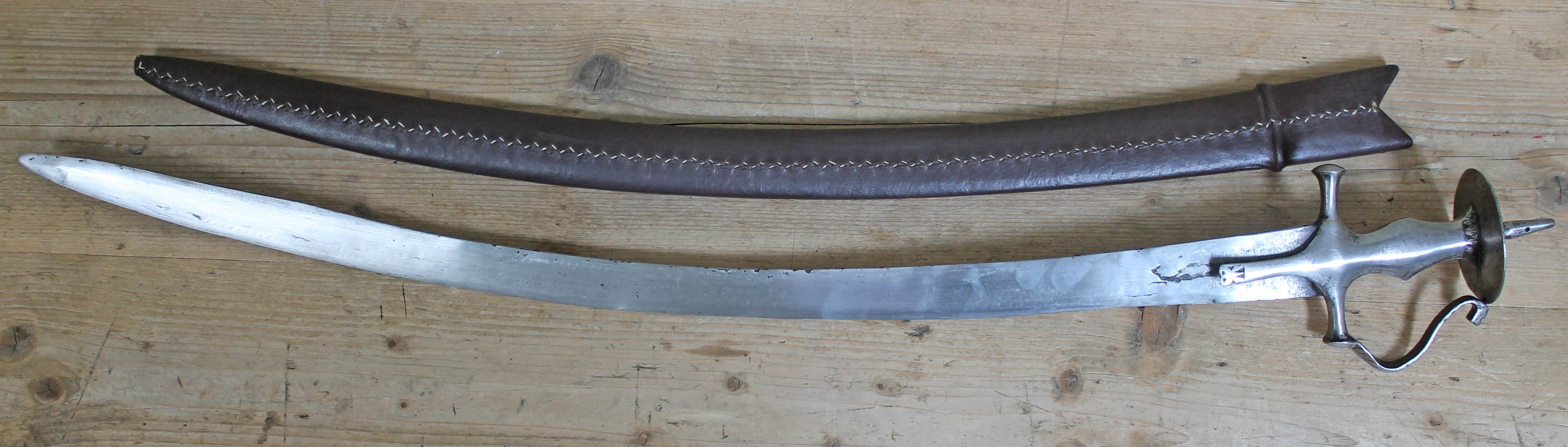 An 18th/19th century Indian cavalry sabre, later scabbard, blade length 78cm.