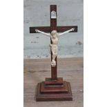 A late 19th century rosewood crucifix with carved ivory figure of Christ, height 34cm.