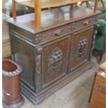 A 19th century continental carved oak cabinet width 137cm, depth 54cm & height 101cm.