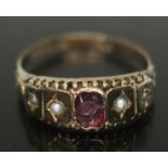 A Victorian hallmarked 9ct gold ring set with pink paste and split pearls, gross wt. 1.84g, size R.