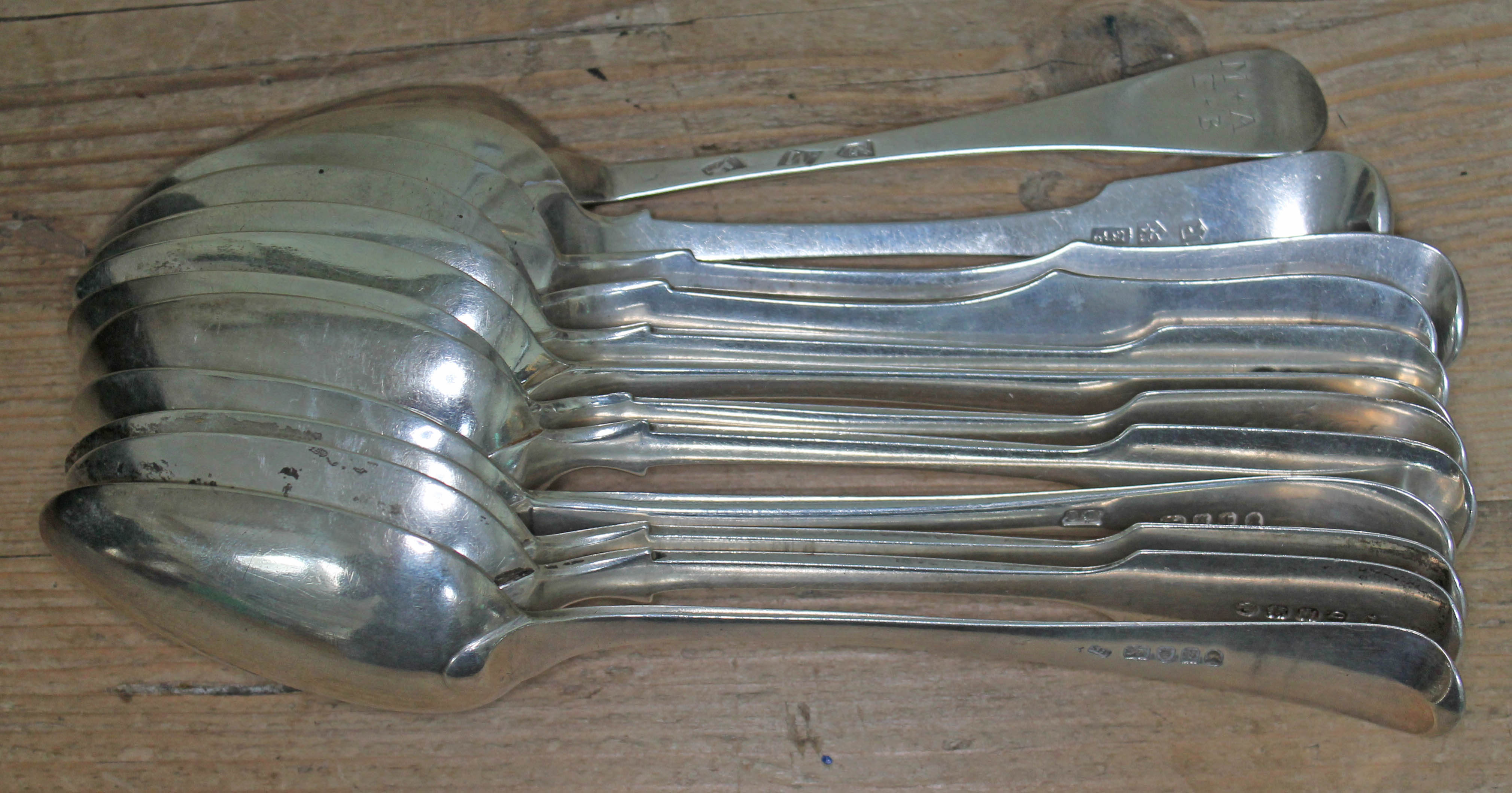 A group of 12 assorted silver desert spoons comprising nine Great Britain, various dates and makers,