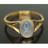A yellow metal ring set with a moonstone cabochon, indistinctly marked '22c', gross wt. 3.01g,