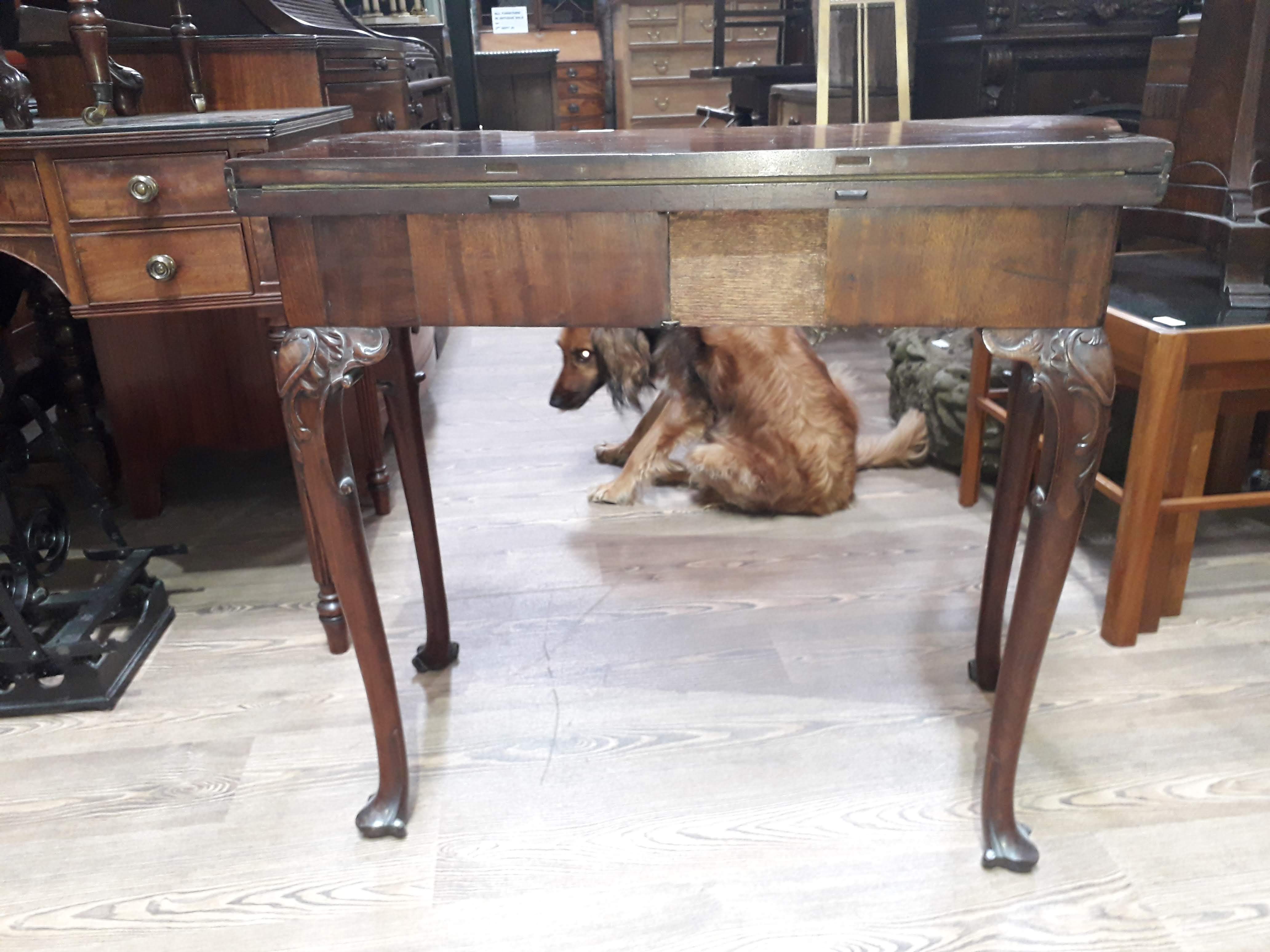 A George II mahogany games table, circa 1740, with fold-over top, the green baize lined interior - Image 4 of 14