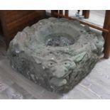 An antique carved sandstone water feature with spouting gargoyles, approx. 50cm x 50cm.