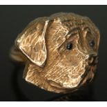 A novelty ring formed as a dog's head and set with blue stones for eyes, marked '9ct', gross wt. 9.