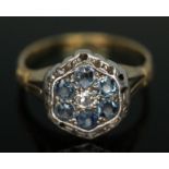 An early 20th century flower head cluster ring set with pale blue and colourless stones, head