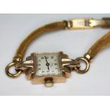 A ladies hallmarked 9ct gold Art Deco style Record wristwatch with gold plated strap.