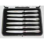 A cased set of six hallmarked silver handled and bladed knives.