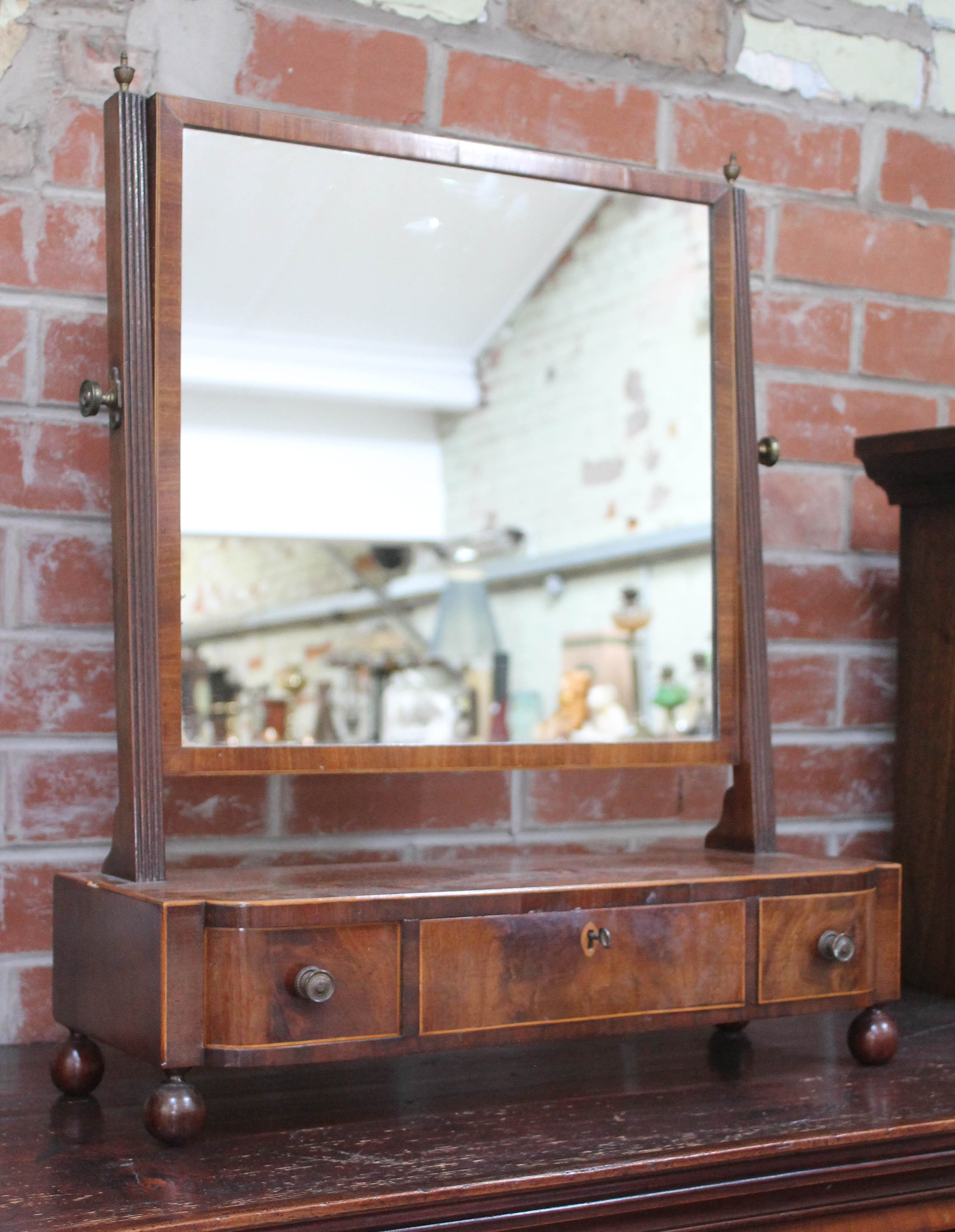 A George III boxwood strung mahogany toilet mirror with three drawers and ball feet, height 67cm.
