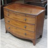 A George III bow front mahogany chest of drawers with rail back, brushing slide and splayed feet,