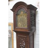 A late Victorian oak long case clock with domed hood, brass and silvered dial with gothic numerals