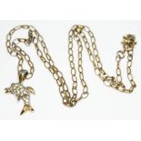 A 9ct gold chain with dolphin pendant, the pendant set with paste and unmarked, the chain