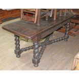 A 17th century and later oak refectory table, three plank top with cleated ends, carved frieze,