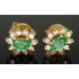 A pair of diamond and emerald cluster ear studs, the cluster measuring approx. 9mm x 7mm, Portuguese