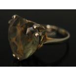 A heart shaped citrine ring set in open work setting with heart cut outs, band marked '9ct', the