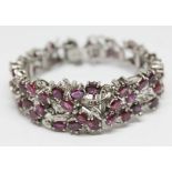 A continental white metal ruby and diamond cocktail bracelet, length 16.5cm, gross wt. 47.29g.