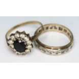 A hallmarked 9ct gold cluster ring and an eternity ring marked '9ct', gross wt. 5.61g, size S & P