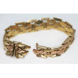 A 9ct two colour bracelet, marked '375' with import marks, length 18.5cm, wt. 20.69g, damaged.