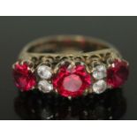 A hallmarked 9ct gold ring set with synthetic rubies and colourless paste, gross wt. 3.15g, size K.