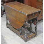 An 18th century oak gate leg table with bobbin legs, min. length 103cm, width 46cm & height 76.5cm.