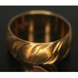 A hallmarked 18ct gold wedding band with wavy design to exterior, wt. 4.61g, size K.