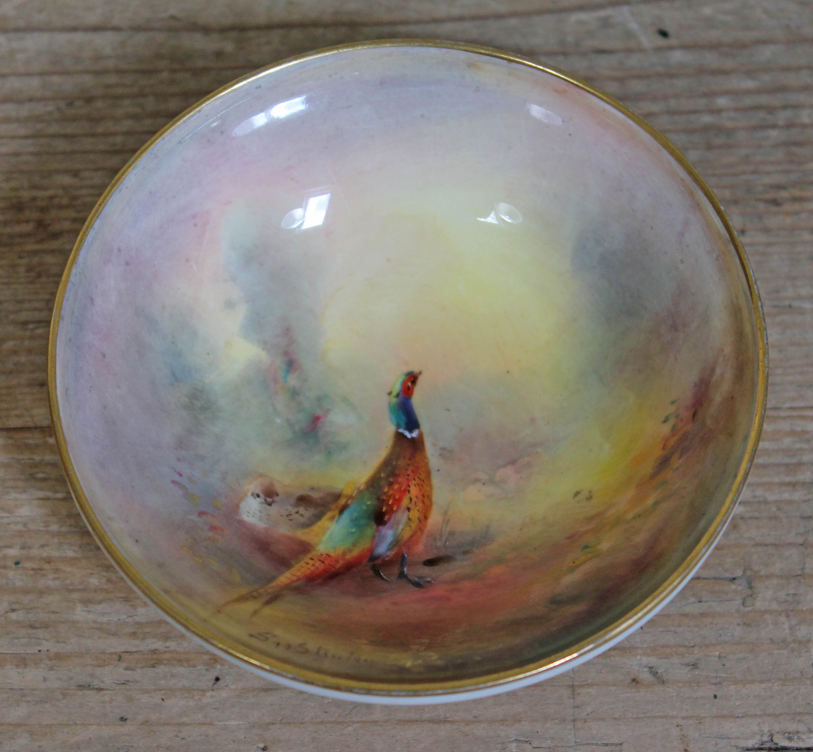 A Royal Worcester dish decorated with a cock and hen pheasant, signed Jas Stinton, numbered 2769,