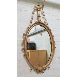 A 19th century gilded oval mirror, length 110cm.