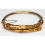 A Victorian Aesthetic bangle, diam. approx. 5.5cm, marked '15ct', wt. 16.54g. Condition - good,