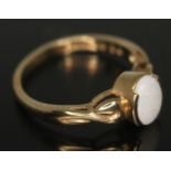 A hallmarked 9ct gold ring set with a precious opal cabochon, gross wt. 2.57g, size O. Condition -