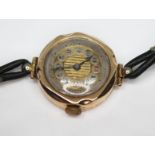 A ladies Art Deco wrist watch, marked '9ct', with leather strap, case diam. 25mm.
