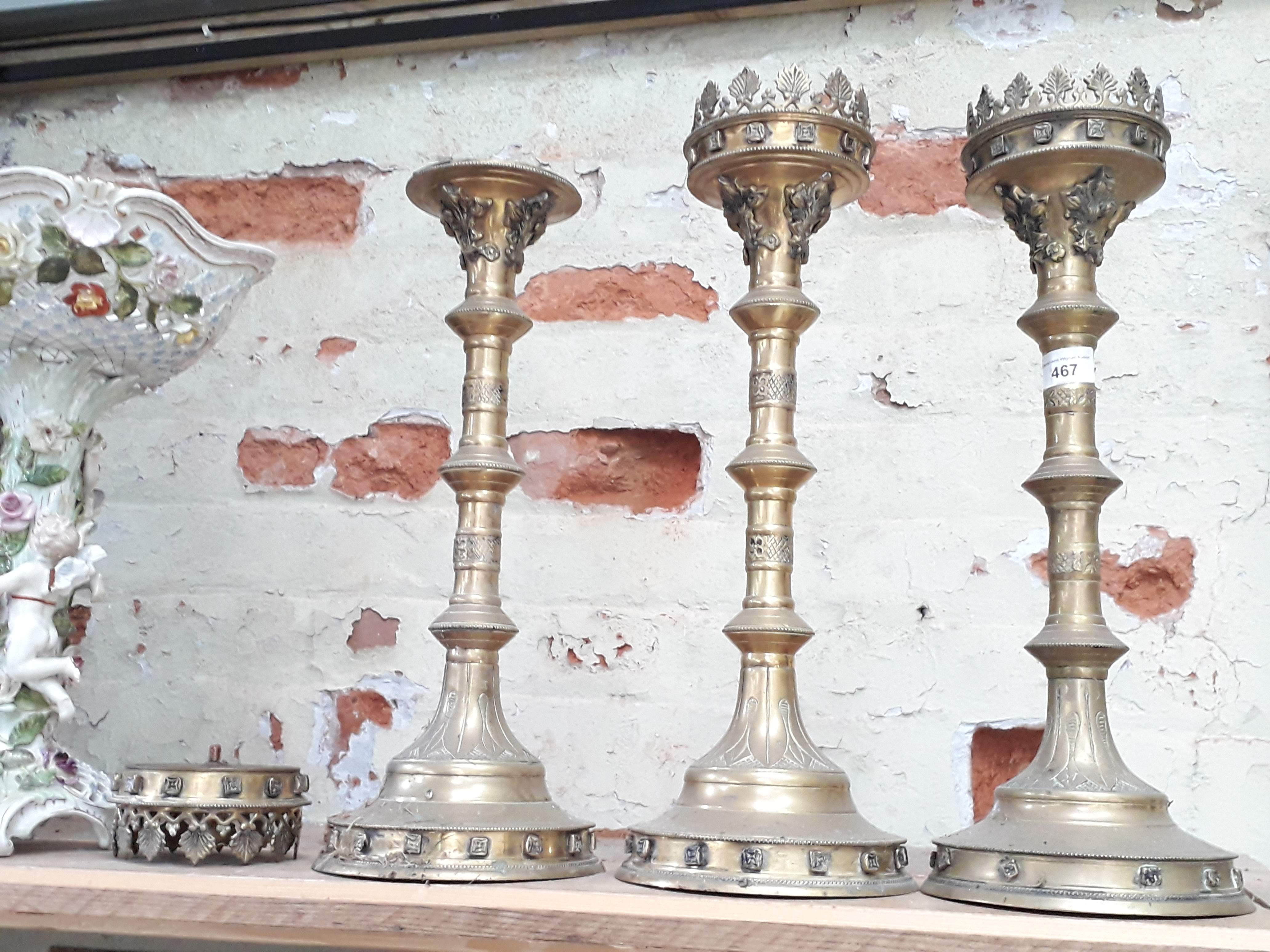 A group of three church brass candlesticks, height 47cm - 49cm.
