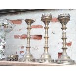 A group of three church brass candlesticks, height 47cm - 49cm.