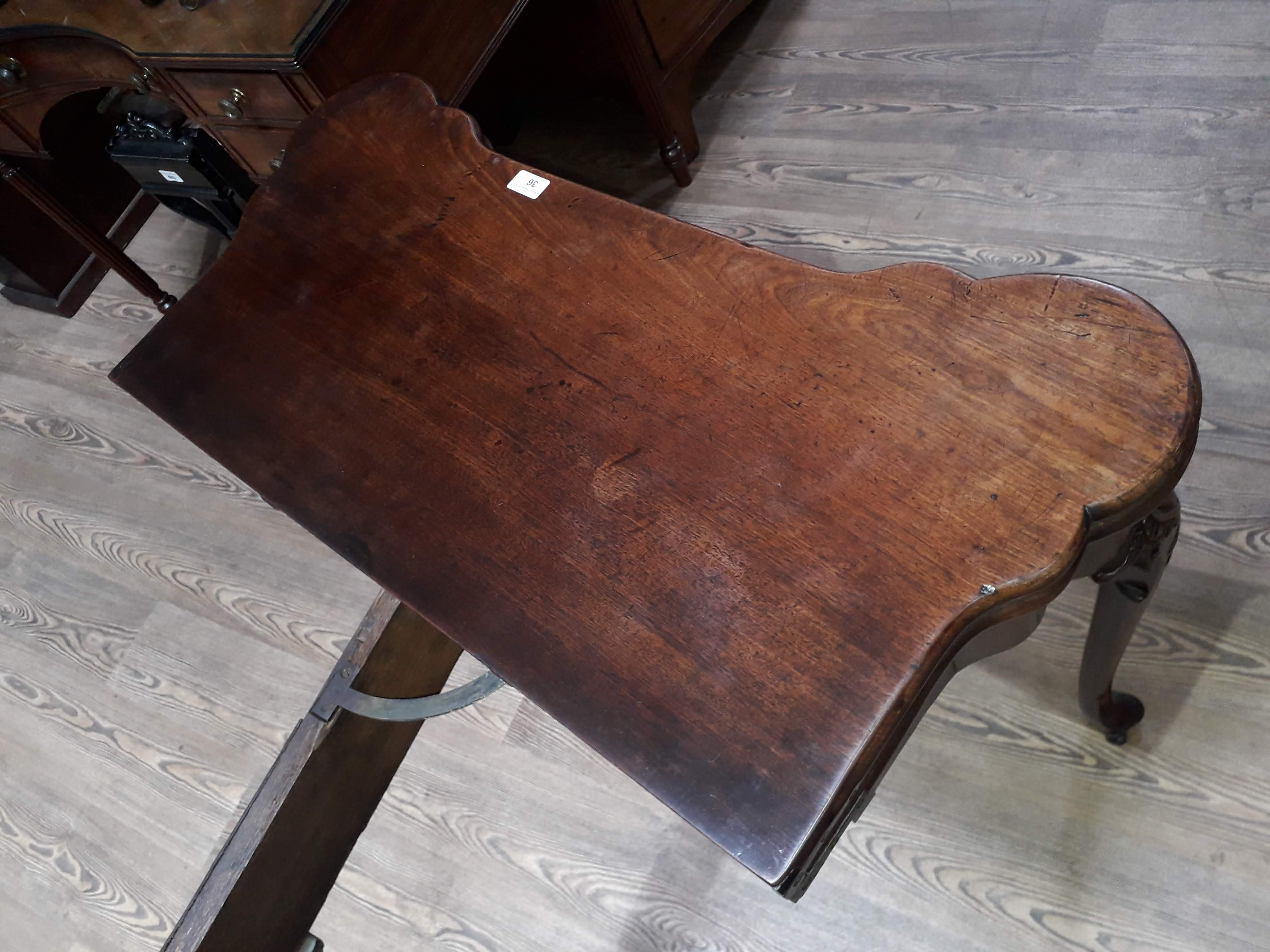 A George II mahogany games table, circa 1740, with fold-over top, the green baize lined interior - Image 6 of 14