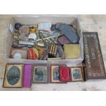 A box of bric a brac including Victorian photographs, old spectacles, Bozo type dog scent bottle,