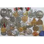 A mixed lot of mainly German WWII medals and badges including some reproduction.