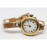 A hallmarked 9ct gold ladies wristwatch with strap marked '9ct', gross wt. 20.59g.