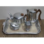 A piquot ware tea set comprising teapot, water jug, milk jug and sugar bowl, on wooden handled tray.