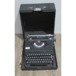 An Olivetti typewriter, with case.