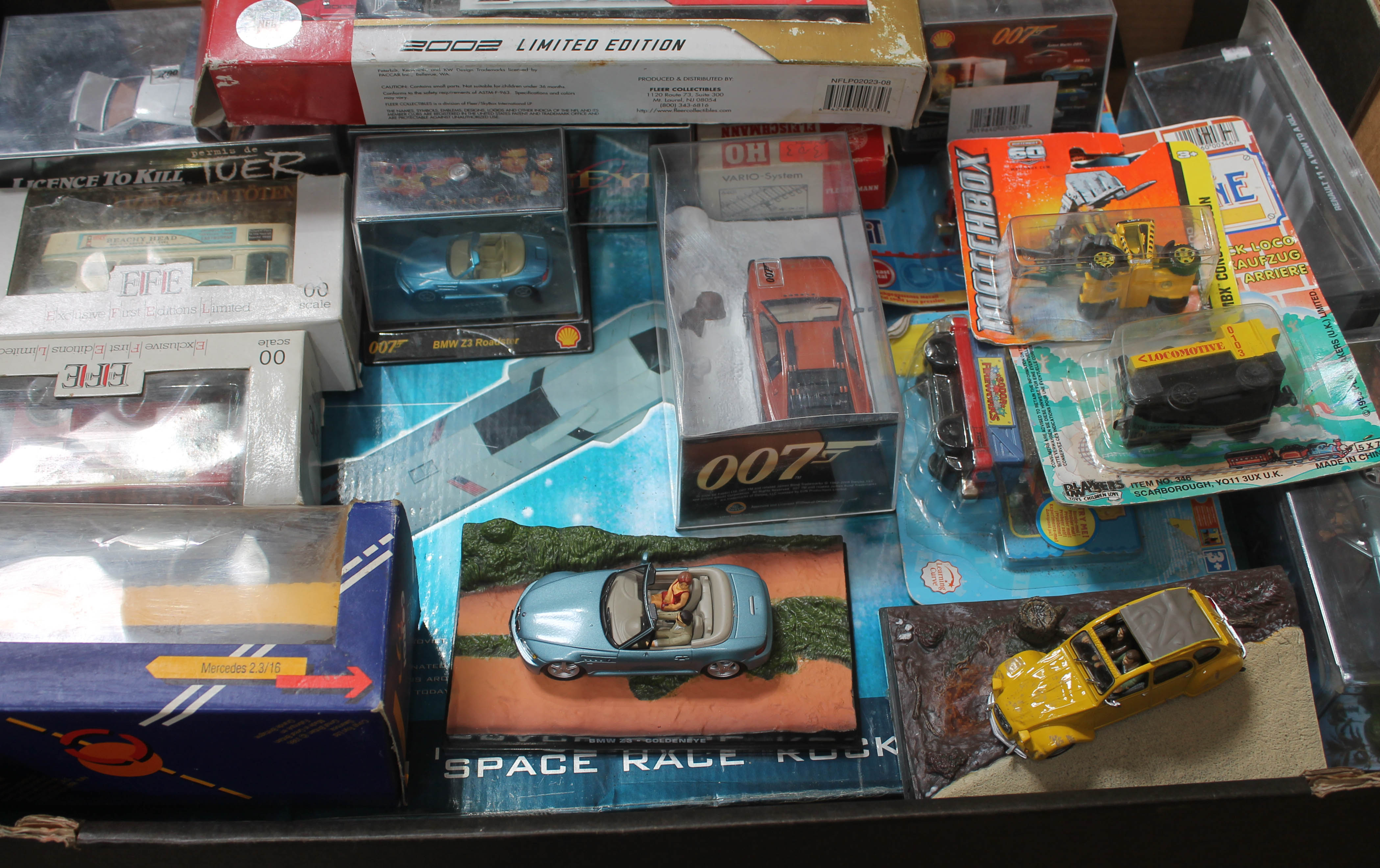 A box of mainly boxed cars, including James Bond etc, and a Marks & Spencer "Build your own Space