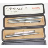 A group of three Parker pens comprising two ballpoints and a fountain pen.