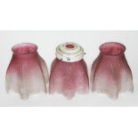 A set of three etched cranberry glass light shades, height approx 6 inches.