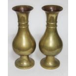 A pair of brass vases, of bulbous form, one with a memorial inscription, height approx 12 inches.