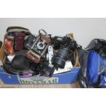 A box and a bag of miscellaneous cameras and accessories, including Sigma SA 300, Olympus, Halina