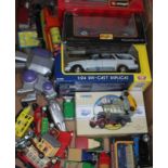 A box of toy cars including some boxed Maisto, Corgi and Burago.