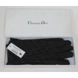A pair of Christian Dior gloves.